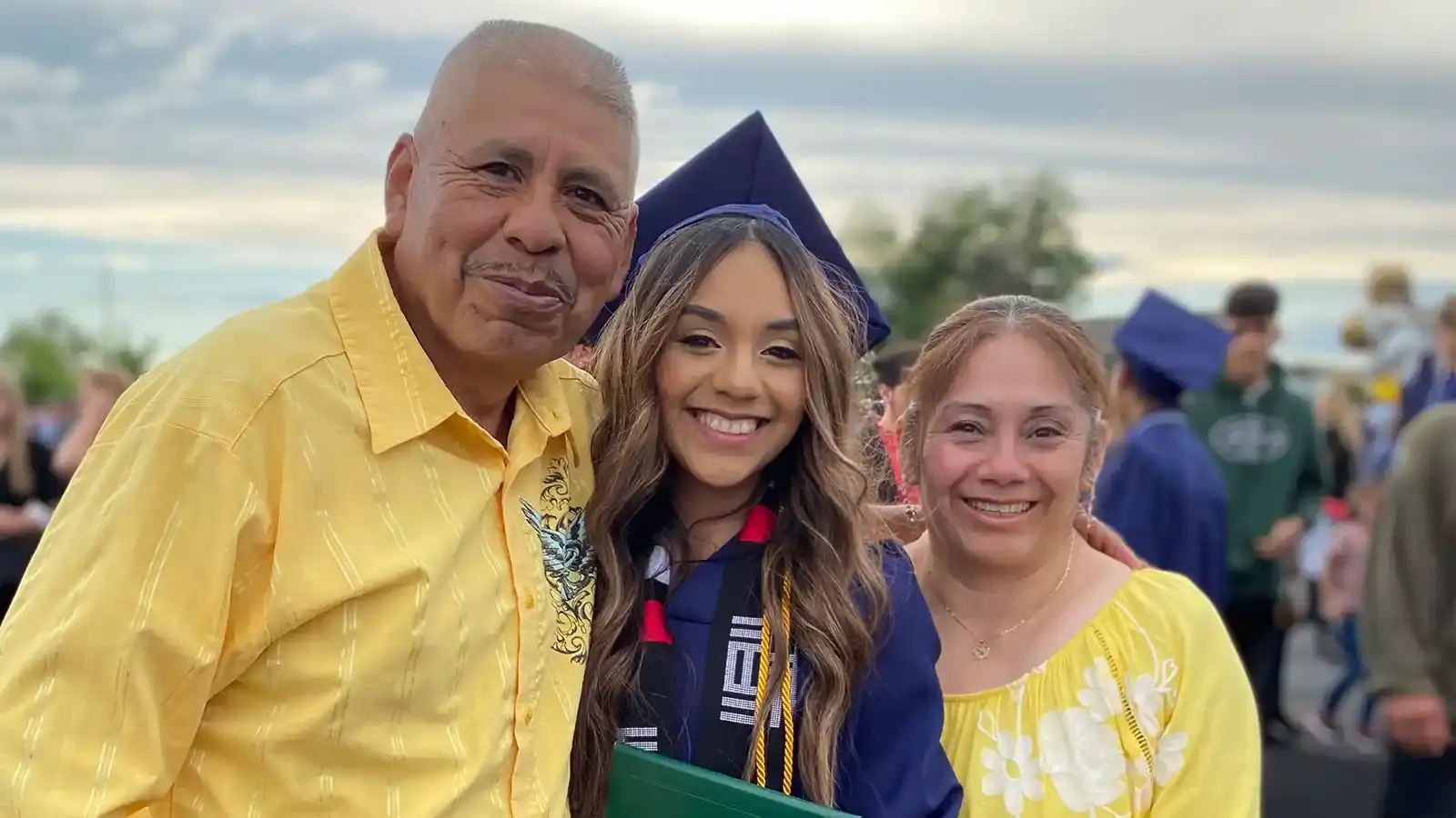 A graduate with her proud parents